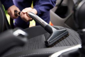 vacuuming-the-seats-in-a-car